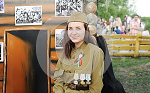 Girl in the uniform of the Soviet soldier of times of World War II