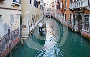 Gondola boat on the narrow canal in Venice