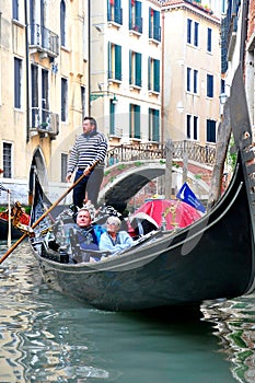 Gondola boat with passengers in Venice, Italy
