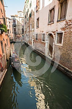 Gondola cruises through canal in Venice, Italy