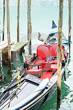 Gondola on Gand Canal in Venice, Italy. Traditional black and white sweater of gondolier in beautiful gondola.