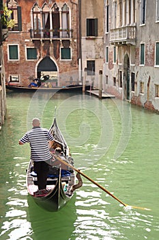 Gondola with gondolier on a canal in Venice, Italy