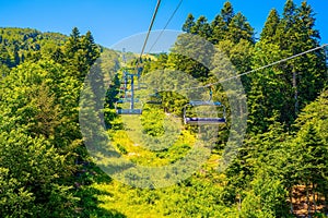 the gondola lift to a forest top ski area in the mountains