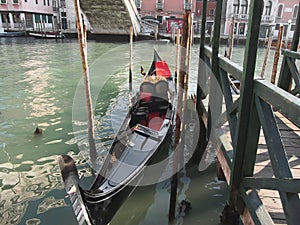 Gondola moored by quay on Venice canal, Italy