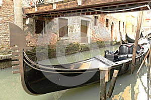 Gondola moored under bridge