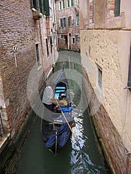 Gondola in a narrow canal of Venice