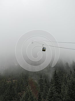 Gondola`s make it down the mountain on a foggy day