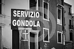 Gondola service sign by canal in Venice