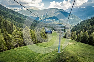 gondola ski lift in mountain ski resort, green forest