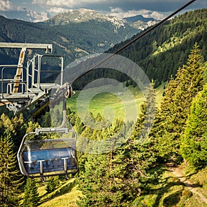 gondola ski lift in mountain ski resort, green forest