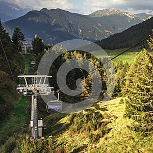 gondola ski lift in mountain ski resort, green forest