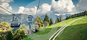 gondola ski lift in mountain ski resort, green forest