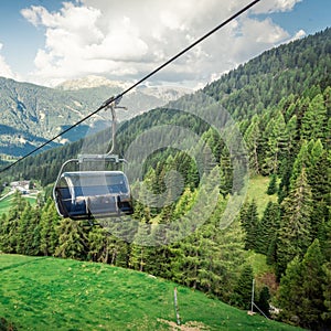 gondola ski lift in mountain ski resort, green forest