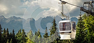 gondola ski lift in mountain ski resort, green forest