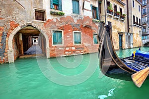 Gondola on small canal in Venice, Italy.
