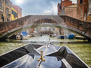 Gondola tour in a canal of Venice