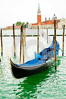 Gondola on traditional pier with wooden pillars