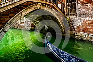 Gondola under the bridges of Venice