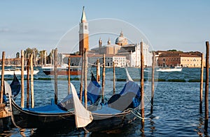 Gondolas against boats and San Giorgio Maggiore island, Venice, Italy