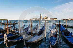 Gondolas against boats and San Giorgio Maggiore island, Venice, Italy