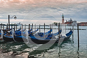 Gondolas anchored by Piazza San Marco with San Giorgio di Maggiore church in Venice