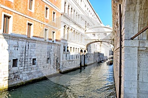 Gondolas floating on canal towards bridge