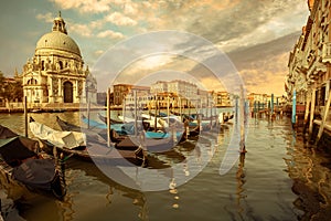 Gondolas moored in Grand Canal and church of Santa Maria della Salute, Venice, Italy