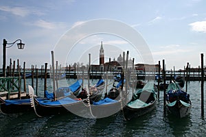 Gondolas moored at the jetty ready to navigate the canals