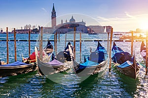 Gondolas moored near San Marco square across from San Giorgio Maggiore island in Venice, Italy. Gondolas were once the main form