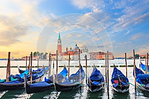 Gondolas moored at the pier in Grand Canal with San Giorgio Maggiore in the background, Venice, Italy