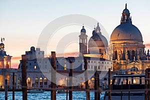 Gondolas moored by Saint Mark square with Cathedral of Santa Maria della Salute on background