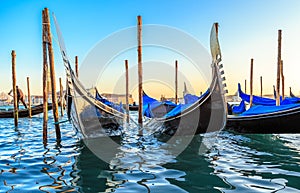 Gondolas moored by Saint Mark square with San Giorgio di Maggiore church in the background - Venice, Venezia, Italy, Europe.
