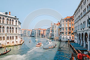 Gondolas and motor boats with tourists traveling the Grand Canal in Venice, Italy