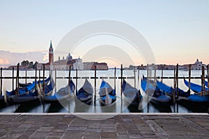 Gondolas movements and canal in Venice before sunset, Italy