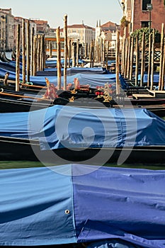 Gondolas parked on the Grand Canal near the Rialto Bridge in Venice, Italy. Travel concept