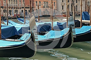 Gondolas parked on the Grand Canal near the Rialto Bridge in Venice, Italy. Travel concept