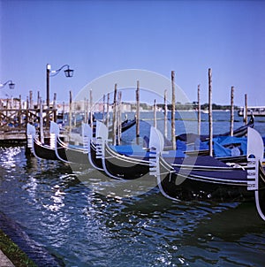 Gondolas in summer in Venice shot with analogue colour film technique