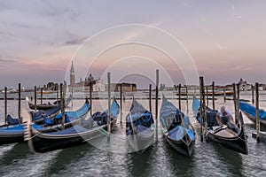 Gondolas at sunset with San Giorgio Maggiore Island in the background, Venice, Italy
