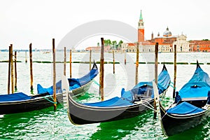 Gondolas on traditional pier with wooden pillars