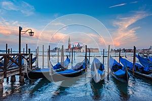 Gondolas at twilight in Venice lagoon, Italia