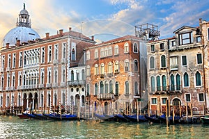 Gondolas of Venice in front of medieval palaces and the dome of