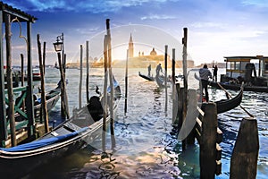 Gondolas in Venice and sunset behind San Giorgio Maggiore church