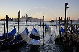 Gondole Stazio Danieliin on sunrise, with Church of San Giorgio Maggiore on the background