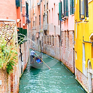 Gondolier on a canal in Venice