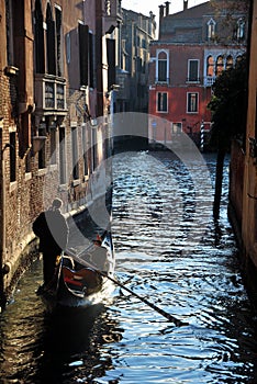 Gondolier in the channel in Venice