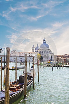 A gondolier drives a gondola with tourists on board near Santa Maria Della Salute in Venice