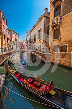 Gondolier in gondola in Venice canal