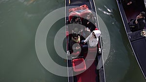 A Gondolier paddles through the Grand canal in Venice