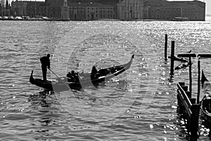 Gondolier rowing tourists in a gondola