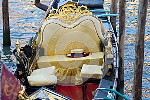 The gondolier`s hat lies on the empty gondola seat